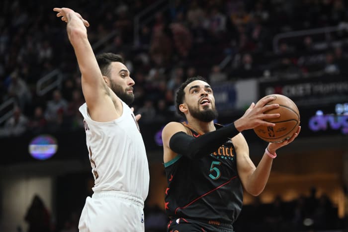 Jan 5, 2024; Cleveland, Ohio, USA; Washington Wizards guard Tyus Jones (5) drives to the basket against Cleveland Cavaliers guard Max Strus (1) during the second half at Rocket Mortgage FieldHouse. Mandatory Credit: Ken Blaze-USA